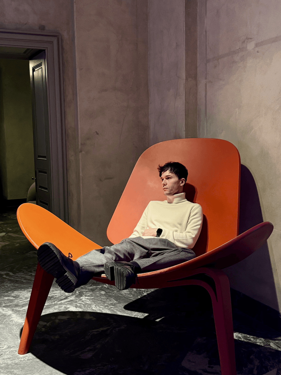 Gregory in an orange chair